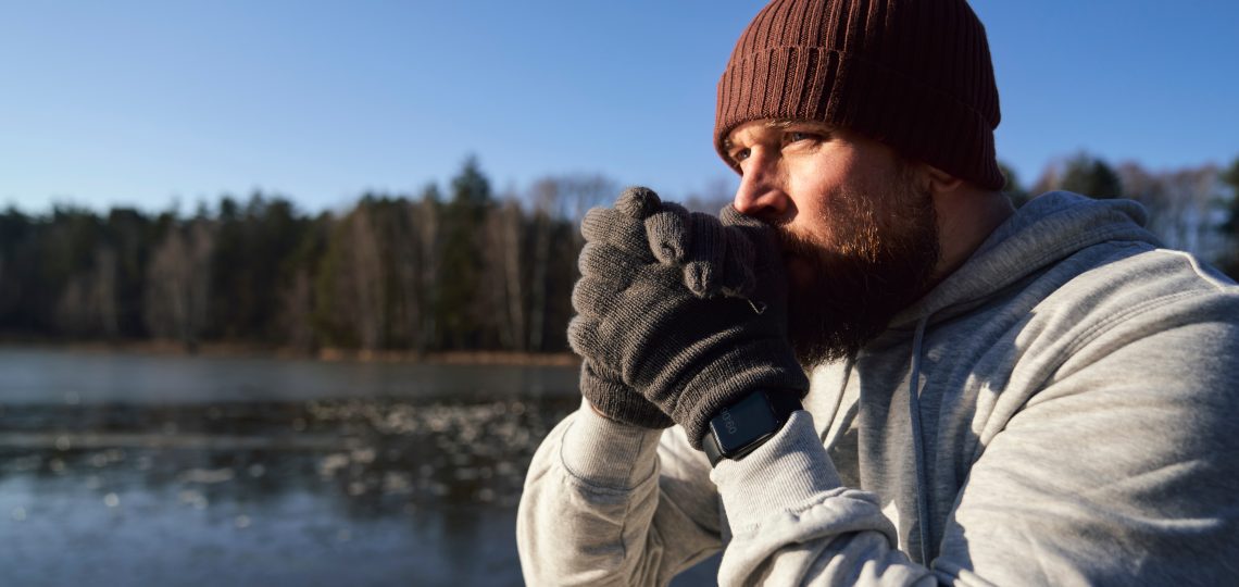 Adult caucasian man warming up before winter swimming