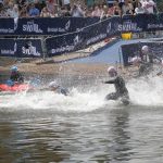 Swimmers in wetsuits running into the water at the start of the Great London Swim 2011