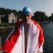 Hector, wrapped in a George Cross flag, looking exhausted after a swim