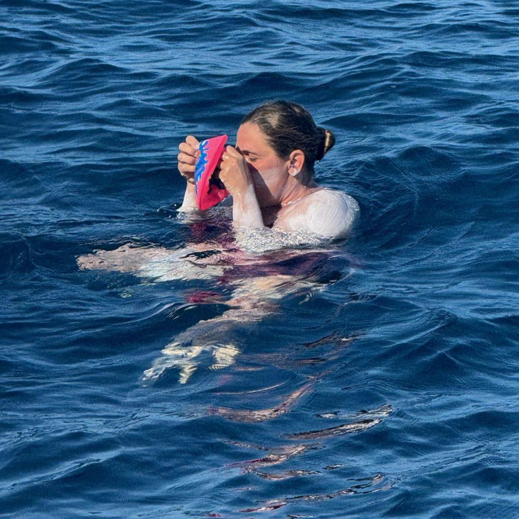 Sidney Russell drinking while in the ocean.