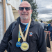 Matthew wearing his Swim Serpentine 2 Mile medal and London Classic medal